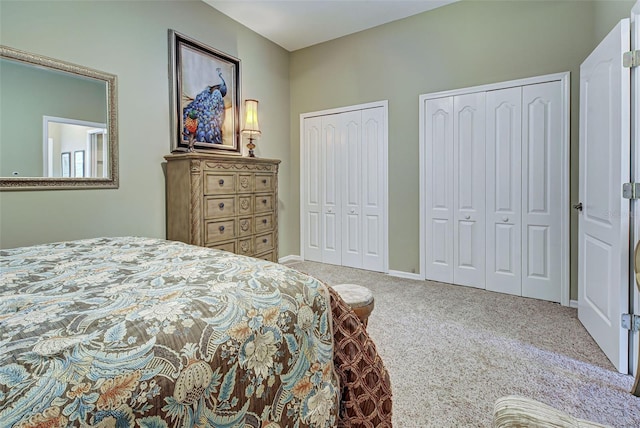 carpeted bedroom featuring two closets