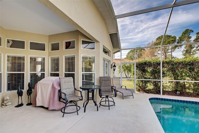 exterior space featuring glass enclosure and a patio