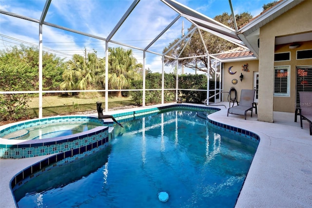 view of swimming pool with an in ground hot tub, a patio, and a lanai