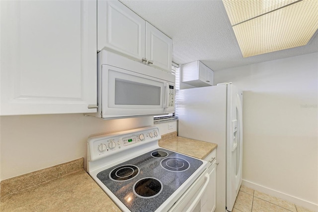 kitchen featuring stove, white cabinets, a textured ceiling, and light tile floors