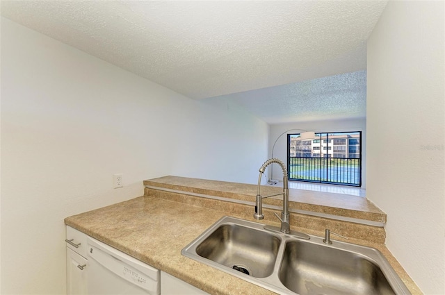 kitchen featuring white cabinets, dishwasher, a textured ceiling, and sink