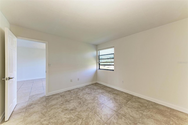 spare room with light tile floors