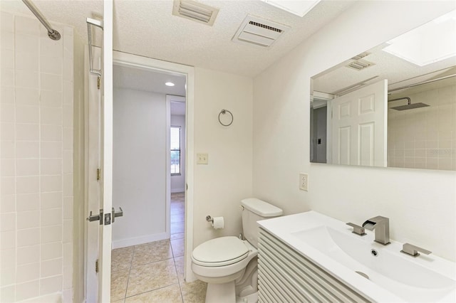 bathroom featuring toilet, vanity with extensive cabinet space, and tile flooring