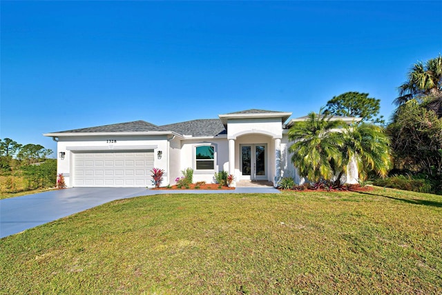 view of front of property featuring a front lawn and a garage