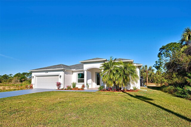 view of front of property with a front lawn and a garage