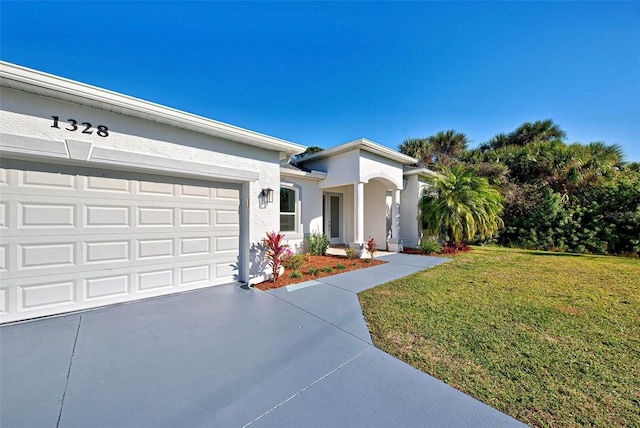 ranch-style home featuring a front lawn and a garage