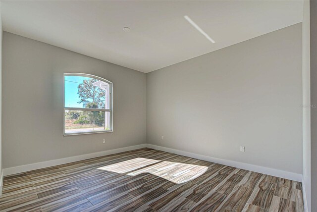 empty room with hardwood / wood-style floors