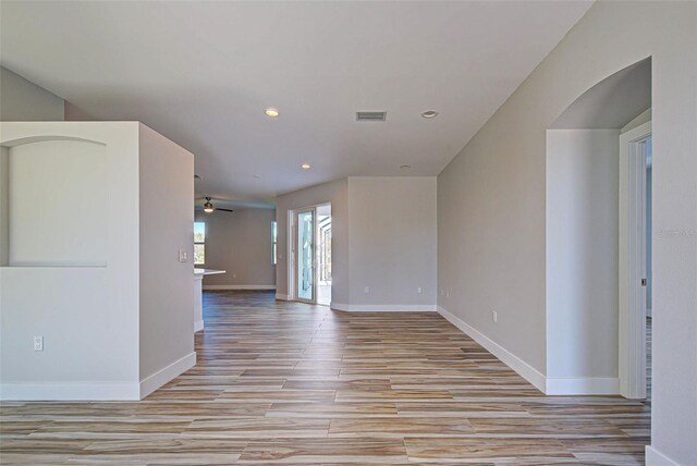 unfurnished room featuring light hardwood / wood-style floors and ceiling fan