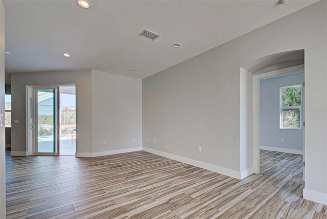 unfurnished room featuring a healthy amount of sunlight and light hardwood / wood-style flooring