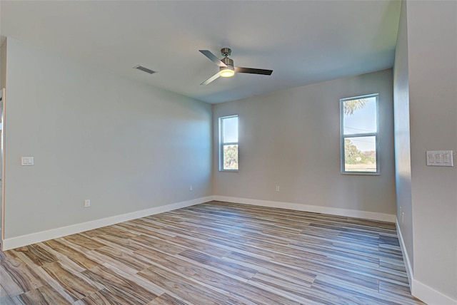 spare room with ceiling fan and light wood-type flooring