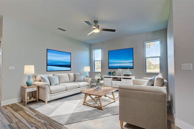 living room featuring ceiling fan and light hardwood / wood-style flooring