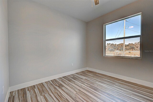 empty room featuring ceiling fan and light wood-type flooring