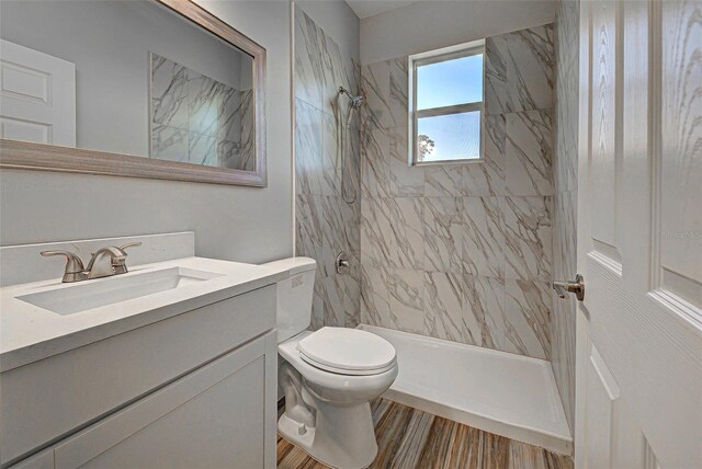 full bathroom with vanity with extensive cabinet space, toilet, and tiled shower / bath