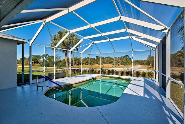 view of pool with a patio area and a lanai