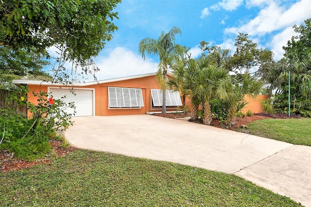 ranch-style home with a front yard and a garage