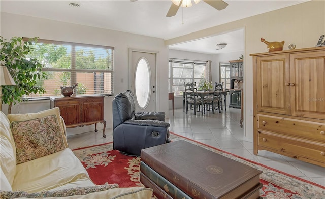 tiled living room with plenty of natural light and ceiling fan