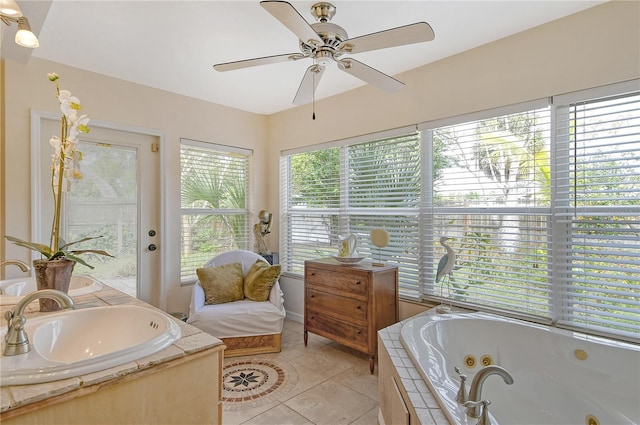 bathroom featuring tiled tub, tile flooring, ceiling fan, and vanity