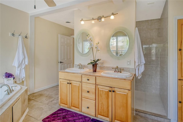 bathroom with a relaxing tiled bath, dual bowl vanity, tile flooring, and ceiling fan