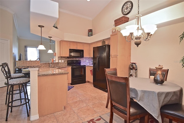 kitchen featuring kitchen peninsula, light tile floors, hanging light fixtures, black appliances, and an inviting chandelier