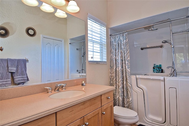 bathroom with toilet and large vanity