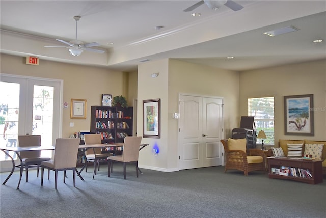 dining space with dark colored carpet, ceiling fan, and a healthy amount of sunlight