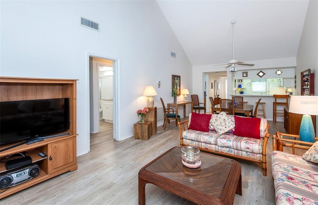 living room featuring high vaulted ceiling, ceiling fan, and light hardwood / wood-style flooring