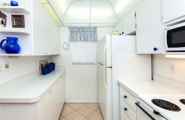 kitchen featuring white cabinetry and light tile floors