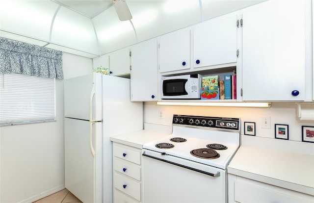 kitchen featuring white appliances, white cabinetry, ceiling fan, and light tile floors