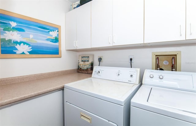 laundry area with washer hookup, washer and clothes dryer, hookup for an electric dryer, and cabinets