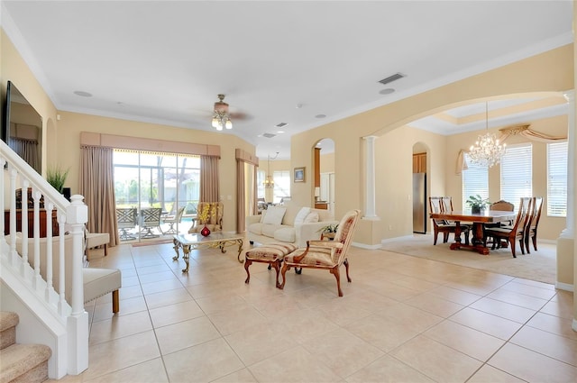 tiled living room featuring crown molding and ceiling fan with notable chandelier