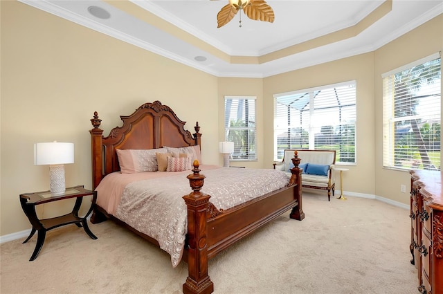 bedroom with a raised ceiling, ornamental molding, light carpet, and ceiling fan