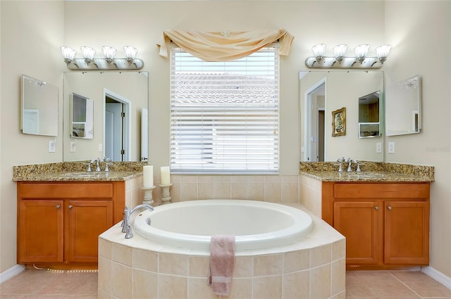 bathroom featuring plenty of natural light, vanity, and tiled tub