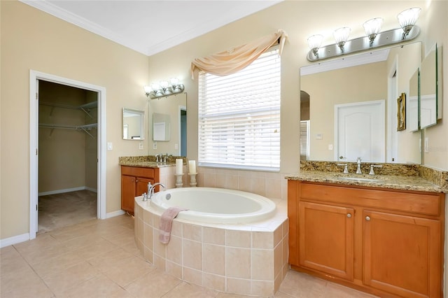 bathroom with tiled tub, crown molding, vanity, and tile patterned floors