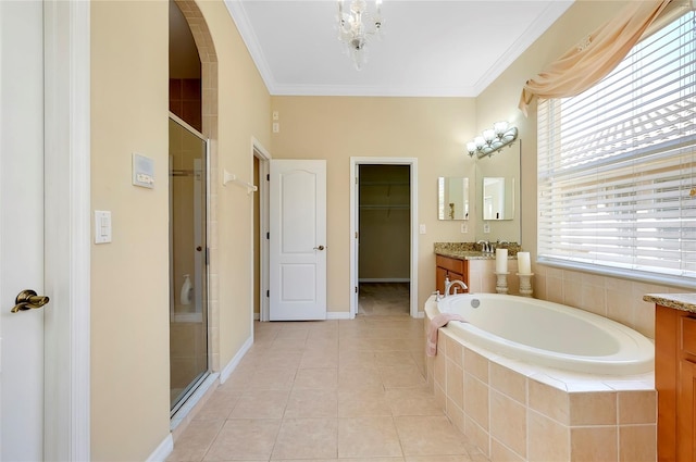 bathroom featuring vanity, tile patterned flooring, ornamental molding, and plus walk in shower