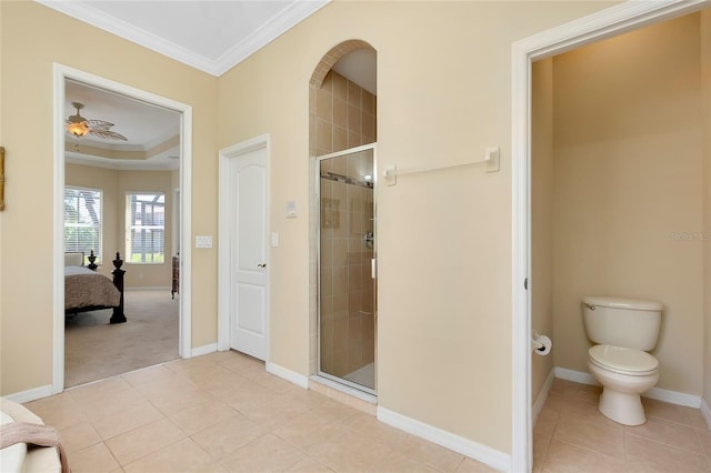 bathroom featuring crown molding, toilet, an enclosed shower, and tile patterned flooring