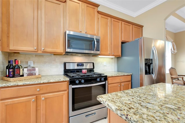 kitchen with tasteful backsplash, ornamental molding, appliances with stainless steel finishes, and light stone counters