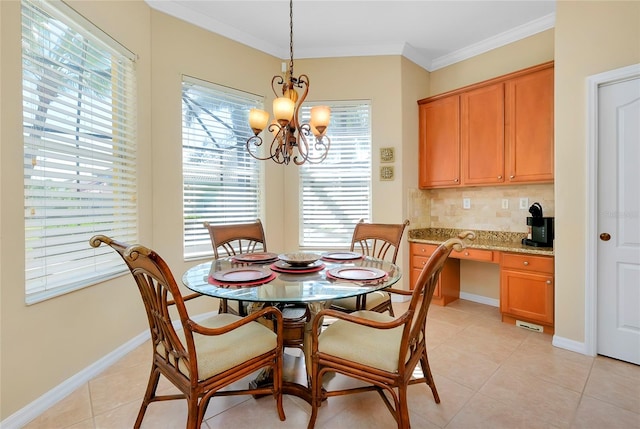 dining area with ornamental molding, built in desk, a notable chandelier, and light tile patterned flooring