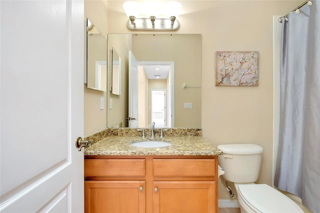 bathroom featuring vanity, toilet, and a shower with shower curtain