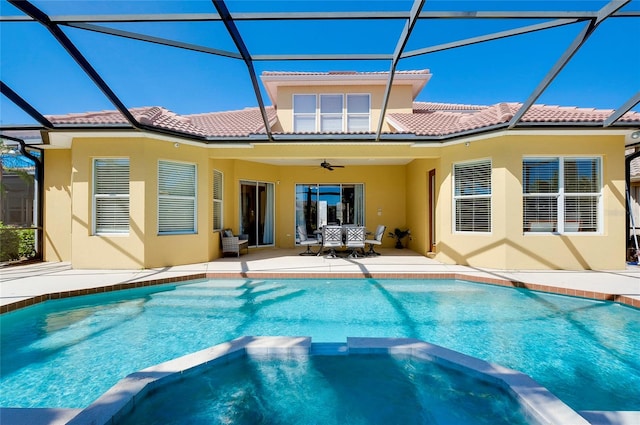 rear view of house with a lanai, a patio area, and ceiling fan