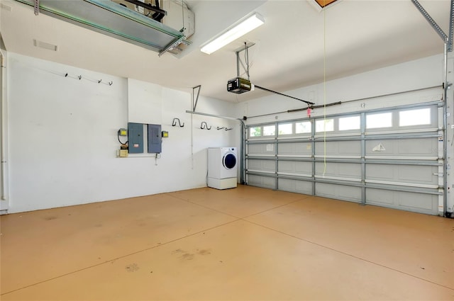 garage featuring washer / clothes dryer, a garage door opener, and electric panel