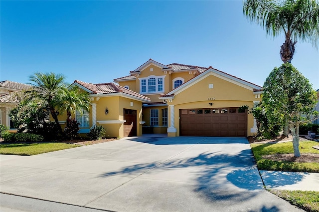 mediterranean / spanish-style home with a garage