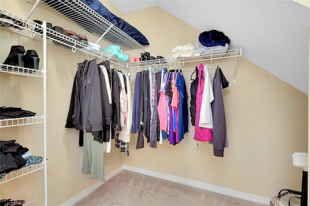 walk in closet featuring carpet floors and vaulted ceiling