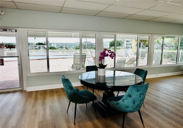 sunroom / solarium with a paneled ceiling