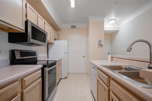 kitchen featuring crown molding, light brown cabinetry, appliances with stainless steel finishes, and light tile floors