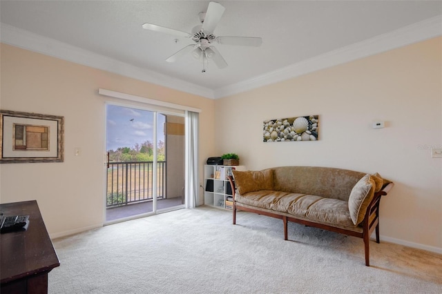 living area featuring light colored carpet, ceiling fan, and crown molding