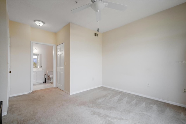 spare room with light carpet and ceiling fan