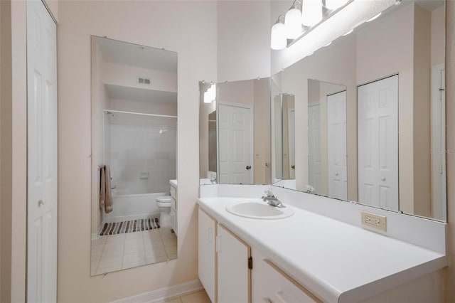 full bathroom featuring tiled shower / bath, toilet, tile flooring, and vanity