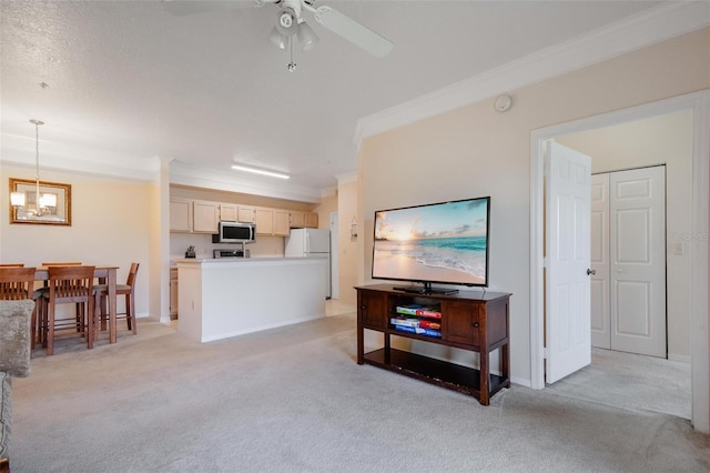 living room featuring light carpet, crown molding, and ceiling fan with notable chandelier