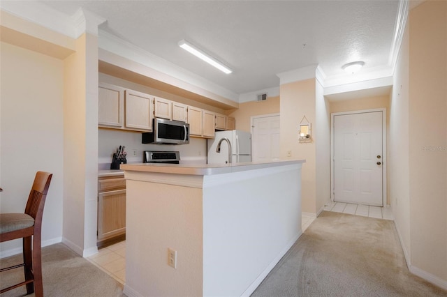 kitchen featuring light colored carpet, crown molding, light brown cabinetry, and white refrigerator