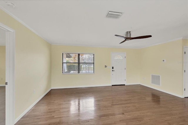 spare room with ceiling fan, wood-type flooring, and ornamental molding